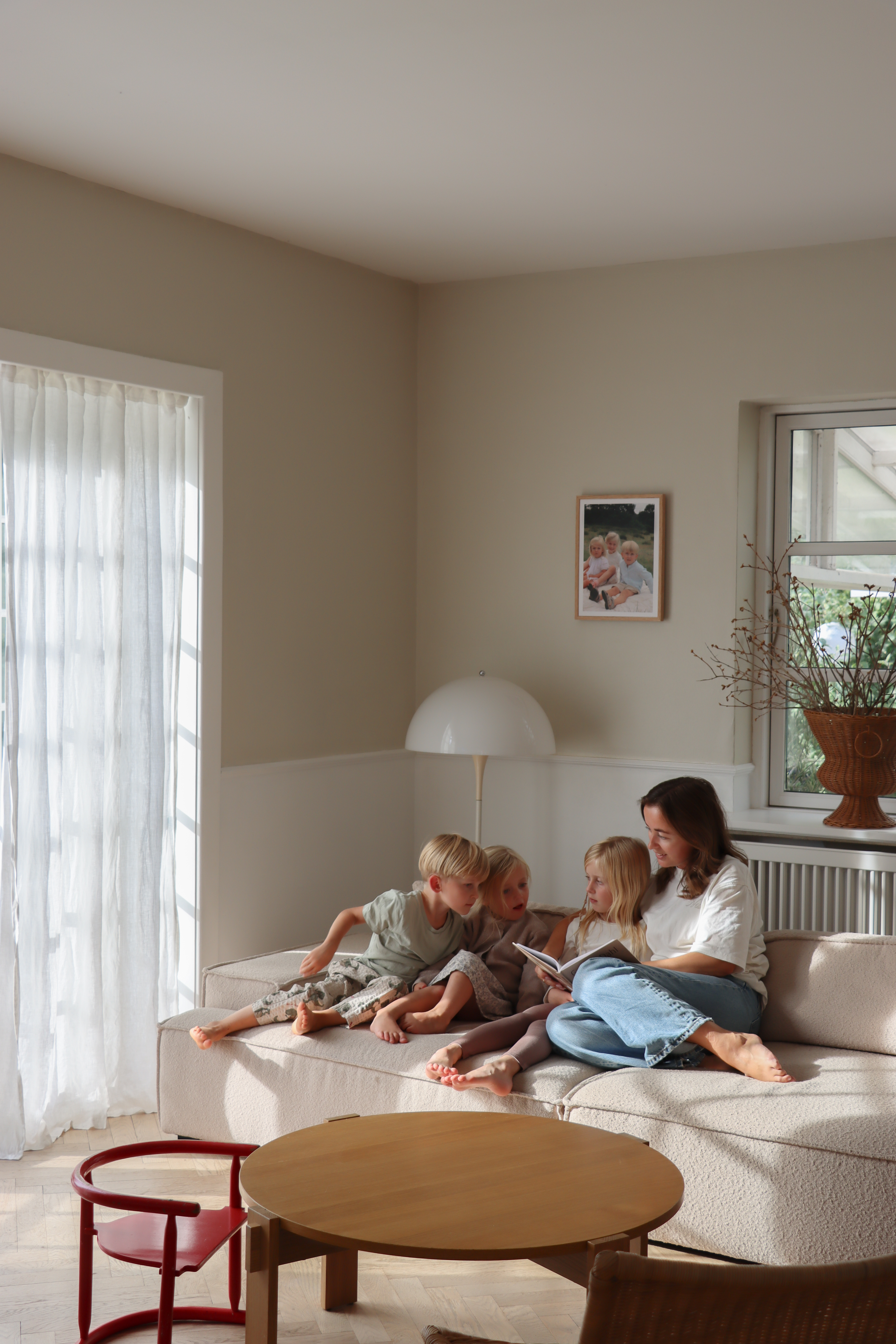 Familie i stue med en Unmute Frame på bagvæggen